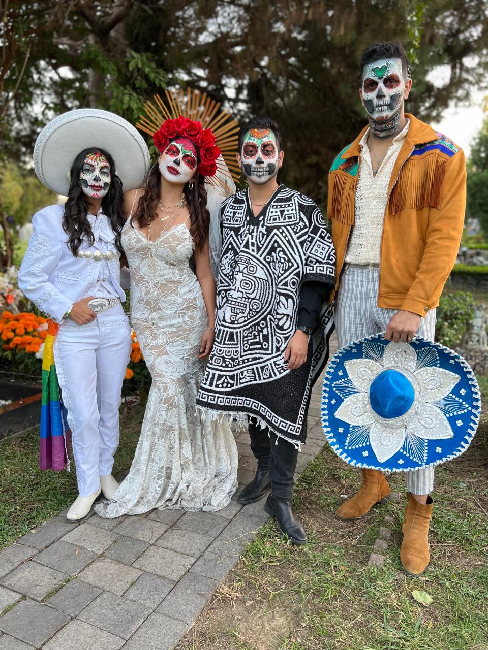 (From left to right) Jessica and Eden Trevino, Ernesto Ruvalcaba and Robin Rodriguez of Los Angeles pose during the Día de Los Muertos celebration at the Hollywood Forever Cemetery in Los Angeles on Saturday, Oct. 28, 2023.