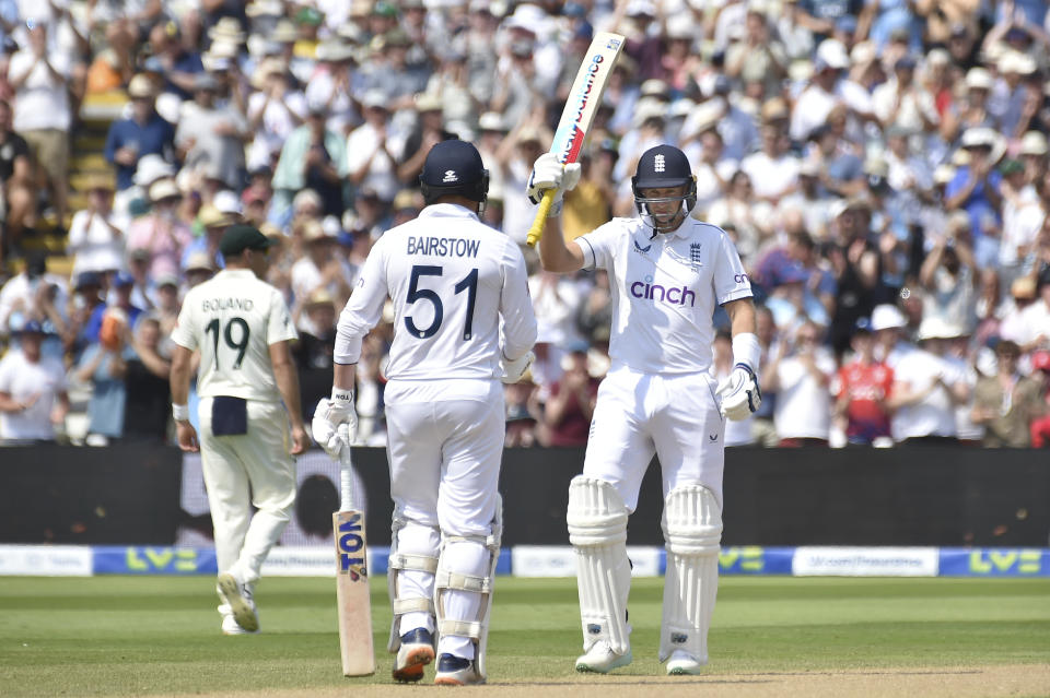England's Joe Root, right, celebrates making 50 runs on day one of the first Ashes Test cricket match between England and Australia at Edgbaston, Birmingham, England, Friday, June 16, 2023. (AP Photo/Rui Vieira)