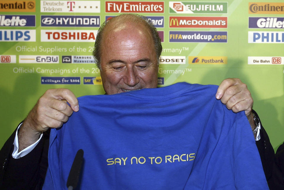 FILE - FIFA President Sepp Blatter holds a t-shirt to promote the FIFA campaign 'Say No To Racism' during a news conference at the Olympic Stadium in Berlin on Wednesday, June 28, 2006. (AP Photo/Markus Schreiber, File)