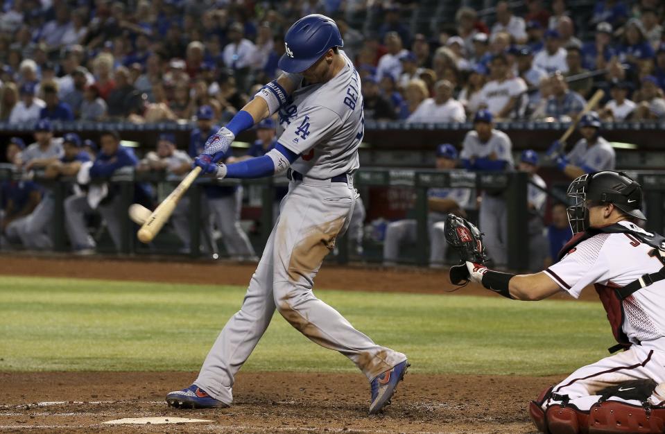 Los Angeles Dodgers' Cody Bellinger (35) connects for a home run as Arizona Diamondbacks catcher Caleb Joseph, right, reaches out for the baseball during the fourth inning of a baseball game Wednesday, June 26, 2019, in Phoenix. (AP Photo/Ross D. Franklin)