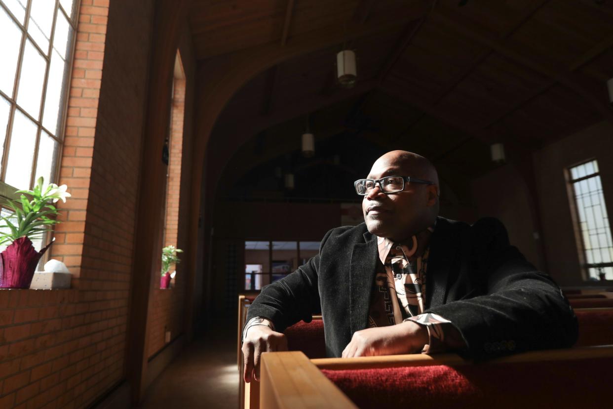 John Handy looks toward the light flowing through a window of Love Fellowship Church, 2636 S.W. Minnesota St., as he pauses from talking about his past life in prison. Handy said he has taken what he learned along the way as his path to now serve God through church.