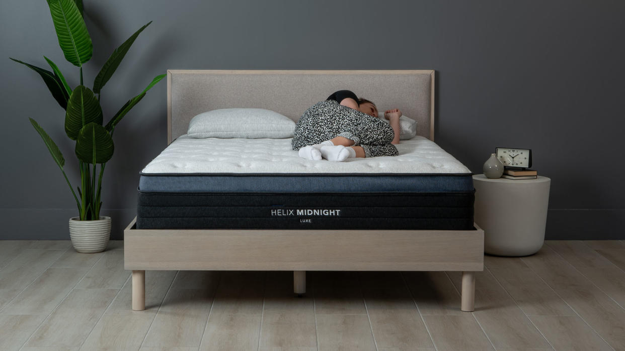  Helix Midnight Luxe mattress with our sleep editor lying on it 