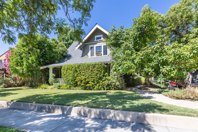 An exterior view of the flora-covered front of the house from Fairview Ave.