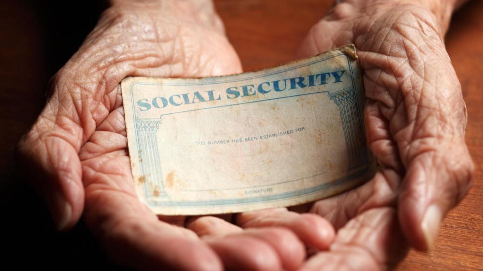 hands holding Social Security card