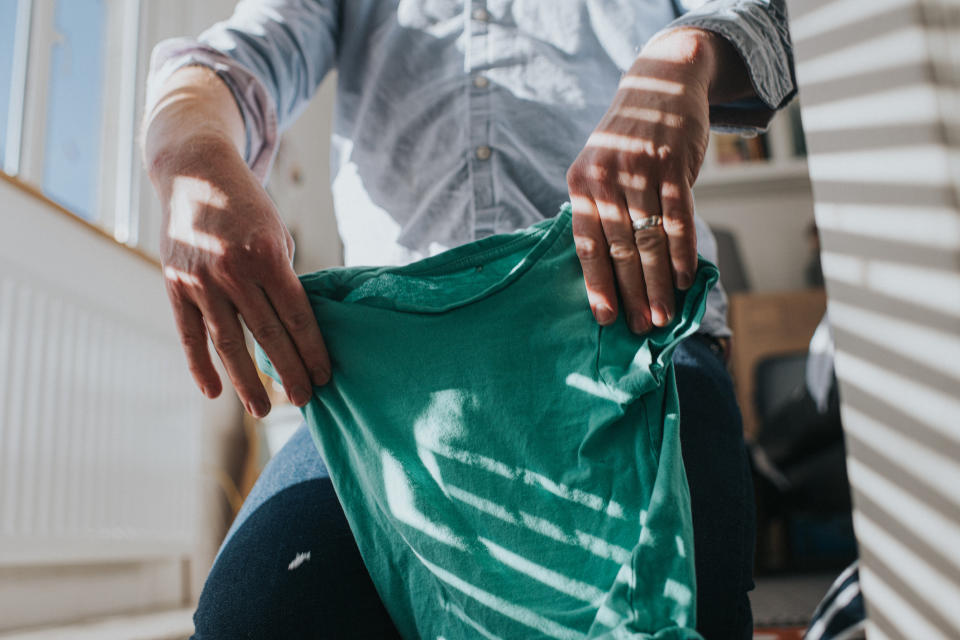 Man folding laundry