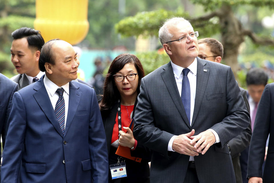 Australian Prime Minister Scott Morrison, right, and his Vietnamese counterpart Nguyen Xuan Phuc while walking at the Presidential Palace in Hanoi, Vietnam, Friday, Aug. 23, 2019. Morrison is on a three-day official visit to Vietnam. (AP Photo/Duc Thanh)