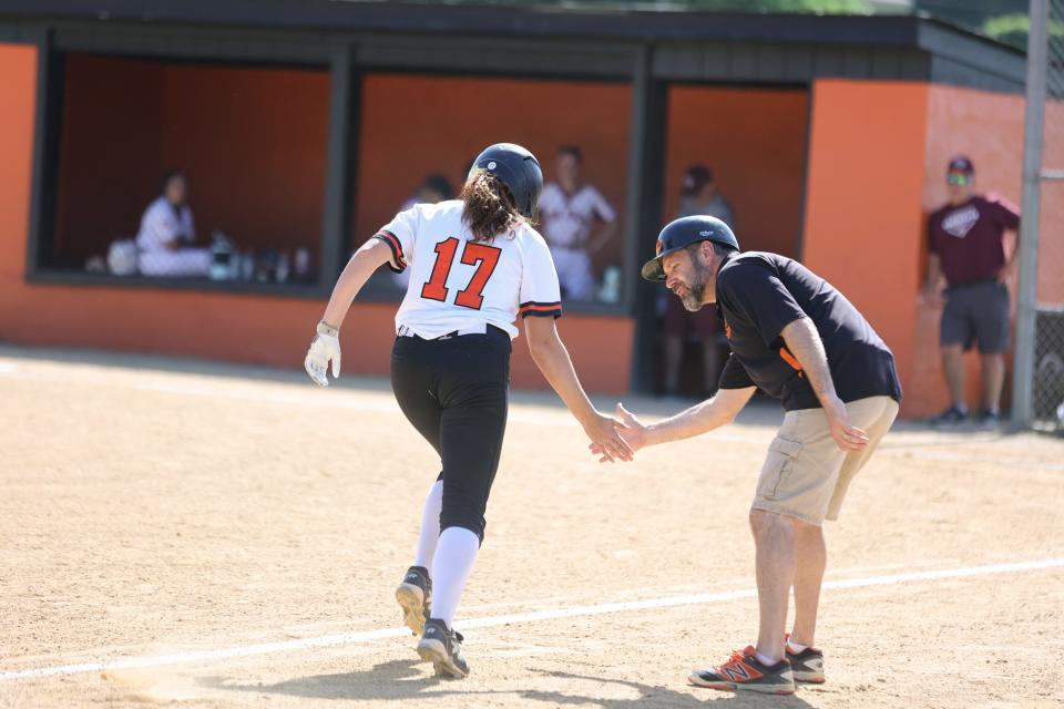 Marlboro's Ava DelSalto, left high fives her coach after hitting a home run at a New Paltz vs Marlboro softball game in Marlboro, NY on Wednesday May 25, 2022. ALLYSE PULLIAM/For the Times Herald-Record