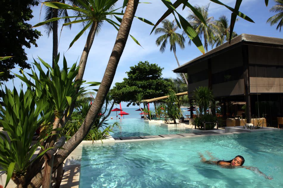 A woman swims in the pool at the Anantara Rasananda resort.