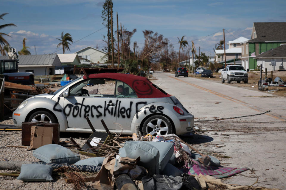 <div class="inline-image__caption"><p>A warning to looters is painted on the side of a car destroyed during Hurricane Ian on Oct. 3 in Pine Island.</p></div> <div class="inline-image__credit">Win McNamee/Getty Images</div>