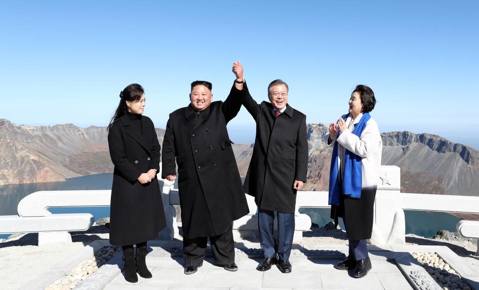 South Korean President Moon Jae-in and North Korean leader Kim Jong Un pose for photographs on the top of Mt. Paektu, North Korea September 20, 2018. Pyeongyang Press Corps/Pool via REUTERS      TPX IMAGES OF THE DAY