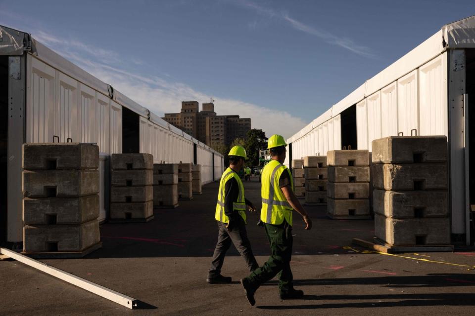 Workers construct a shelter facility on New York’s Randall’s Island in October. (AFP via Getty Images)