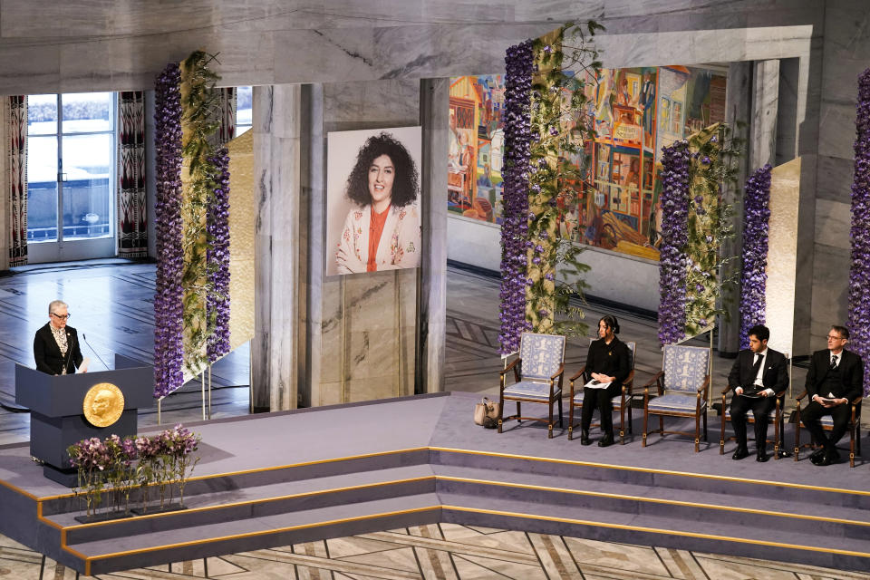 The awarding of the Nobel Peace Prize for 2023 in Oslo City Hall, Oslo, Norway, Sunday, Dec. 10, 2023. The children of imprisoned Iranian activist Narges Mohammadi, shown on the screen, are set to accept this year’s Nobel Peace Prize on her behalf. Mohammadi is renowned for campaigning for women’s rights and democracy in her country. (Fredrik Varfjell/NTB via AP)