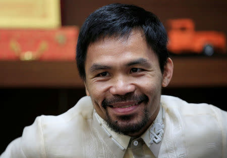 Senator and boxing champion Manny "Pacman" Pacquiao smiles during a Reuters interview inside his office at the Senate headquarters in Pasay city, metro Manila, Philippines September 28, 2016. REUTERS/Romeo Ranoco