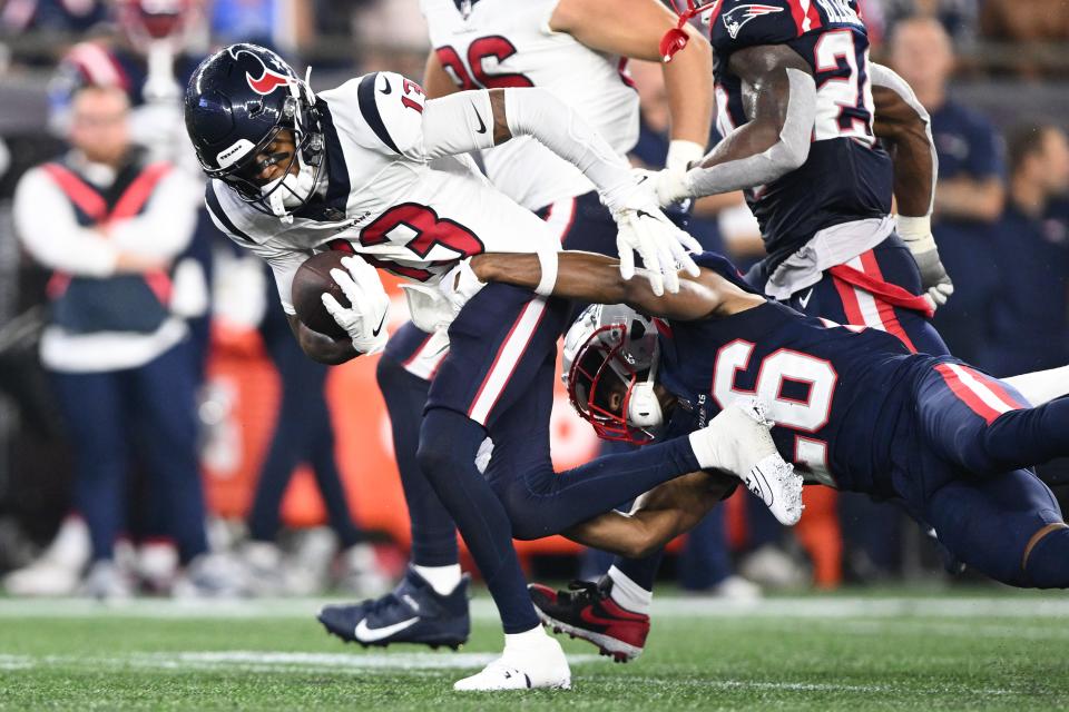 Aug 10, 2023; Foxborough, Massachusetts, USA; New England Patriots cornerback Shaun Wade (26) tackles Houston Texans wide receiver Tank Dell (13) during the first half at Gillette Stadium. Mandatory Credit: Brian Fluharty-USA TODAY Sports