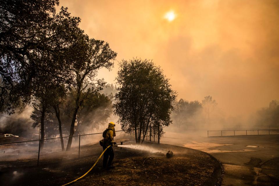 Fire Fighters with Cal Fire work to protect the St. Helena Water Treatment Plant from the Glass Fire in Napa Valley, California on September 27, 2020. (Samuel Corum/AFP via Getty Images)