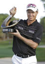 John Senden, of Australia, holds up the trophy after winning Valspar Championship golf tournament at Innisbrook, Sunday, March 16, 2014, in Palm Harbor, Fla. (AP Photo/Chris O'Meara)