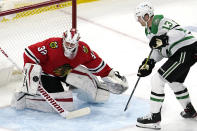 Chicago Blackhawks goaltender Kevin Lankinen, left, makes a save on a shot by Dallas Stars defenseman Mark Pysyk during the second period of an NHL hockey game in Chicago, Sunday, May 9, 2021. (AP Photo/Nam Y. Huh)