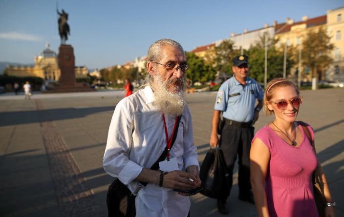 Mile Mrvalj (c) takes tour groups around important sites for Zagreb's "invisible" homeless community (AFP Photo/Damir SENCAR)