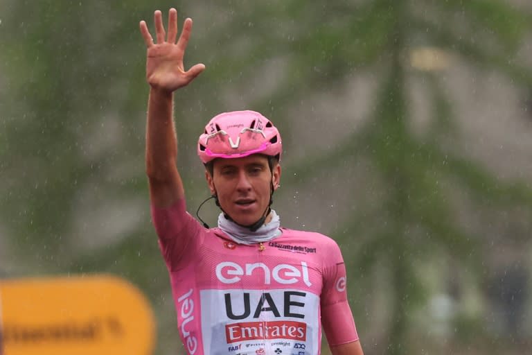 Tadej Pogacar holds five fingers aloft as he crosses the line (Luca Bettini)