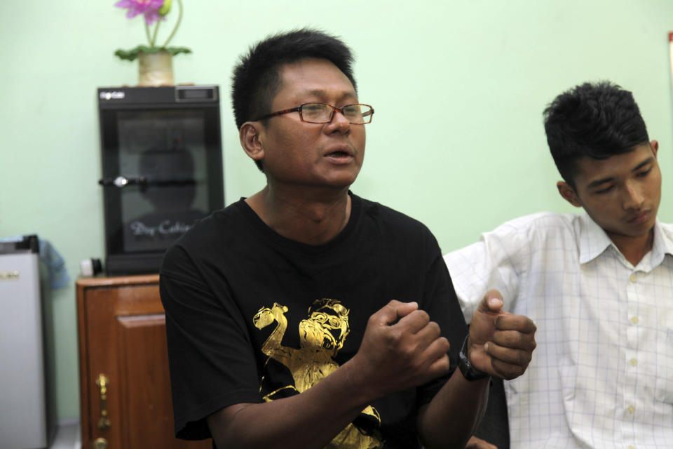 In this photo taken on Tuesday, March 11, 2014, Kyaw Kyaw Myaing, a township journalist of Golden Fresh Land daily newspaper, talks during an interview as his colleague Myat Thu Aung, right, in Yangon, Myanmar. One year after publishers and editors took advantage of a decision by the country's nominally civilian government to lift a half-century-old ban on private dailies, the feeling of euphoria is fading. The struggle to compete with state-owned papers for advertisers and circulation have made it impossible for many to forge on. Golden Fresh Land, published its last edition Wednesday, March 12. It is the first well-known private daily to fold, but 11 others that are still publishing also appear to be struggling.(AP Photo/Khin Maung Win)