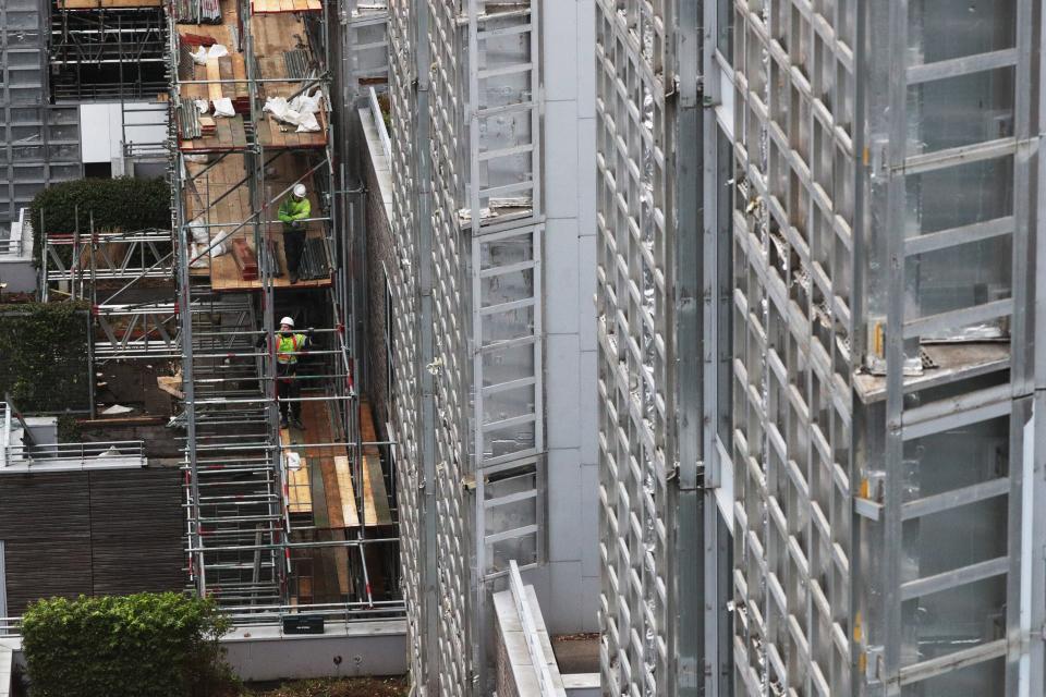 Contractors undertake works at a residential property in Paddington as part of a project to remove and replace non-compliant cladding (PA)