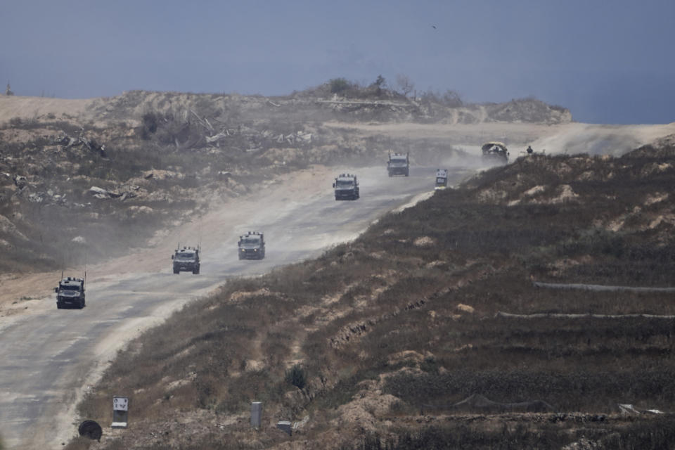 A column of Israeli military vehicles leave the Gaza Strip, as seen from southern Israel, Wednesday, June 12, 2024. (AP Photo/Tsafrir Abayov)