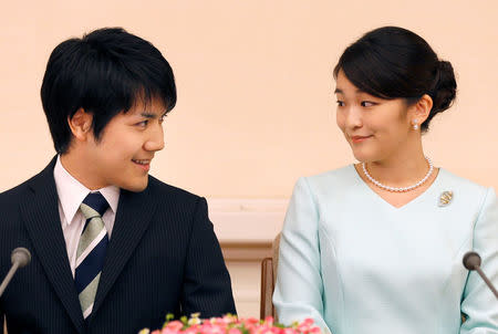 Princess Mako, the elder daughter of Prince Akishino and Princess Kiko, and her fiancee Kei Komuro, a university friend of Princess Mako, smile during a press conference to announce their engagement at Akasaka East Residence in Tokyo, Japan, September 3, 2017. REUTERS/Shizuo Kambayashi/Pool