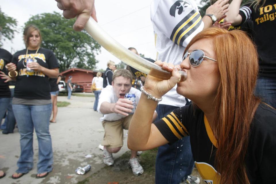 In this Sept. 6, 2008, photo University of Iowa student Caryn Vaneck drinks from a beer bong while tailgating before a football game in Iowa City, Iowa. The Princeton Review named the University of Iowa as the nations's best party school Monday, Aug. 5, 2013, on a list determined by 126,000 students in a nationwide survey. (AP Photo/Iowa City Press Citizen, Matthew Holst)