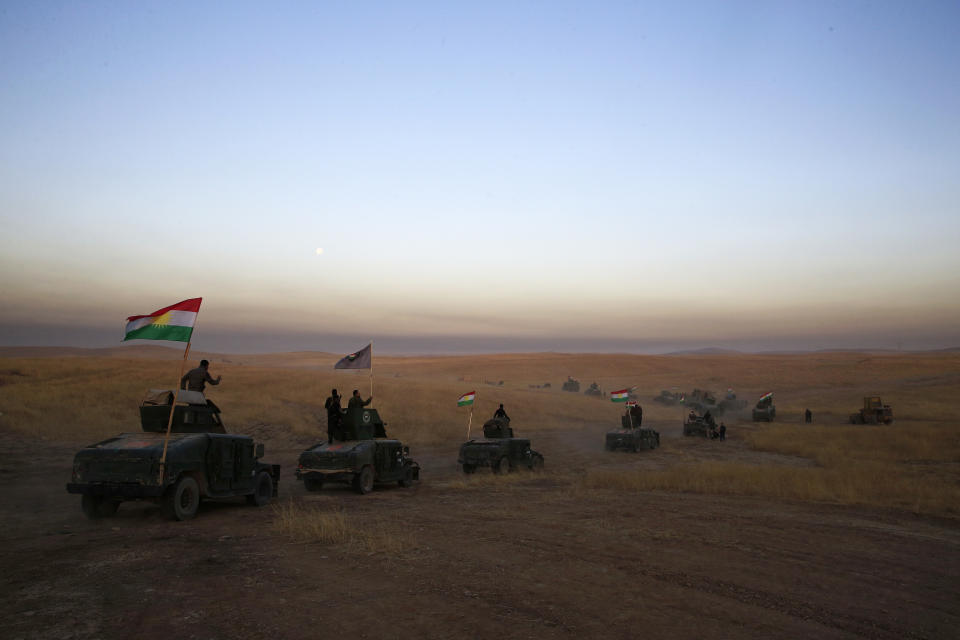 FILE -- In this Oct. 17, 2016 file photo, a Kurdish Peshmerga convoy drives towards a frontline in Khazer, about 30 kilometers (19 miles) east of Mosul, Iraq. Syria’s Kurds have been America’s partner in fighting the Islamic State group for nearly four years. Now they are furious over an abrupt U.S. troop pull-back that exposes them to a threatened attack by their nemesis, Turkey. The surprise U.S. pull-back from positions near the Turkish border, which began Monday, Oct. 7, 2019, stung even more because the Kurds have been abandoned before by the United States and other international allies on whose support they'd pinned their aspirations. (AP Photo/Bram Janssen, File)