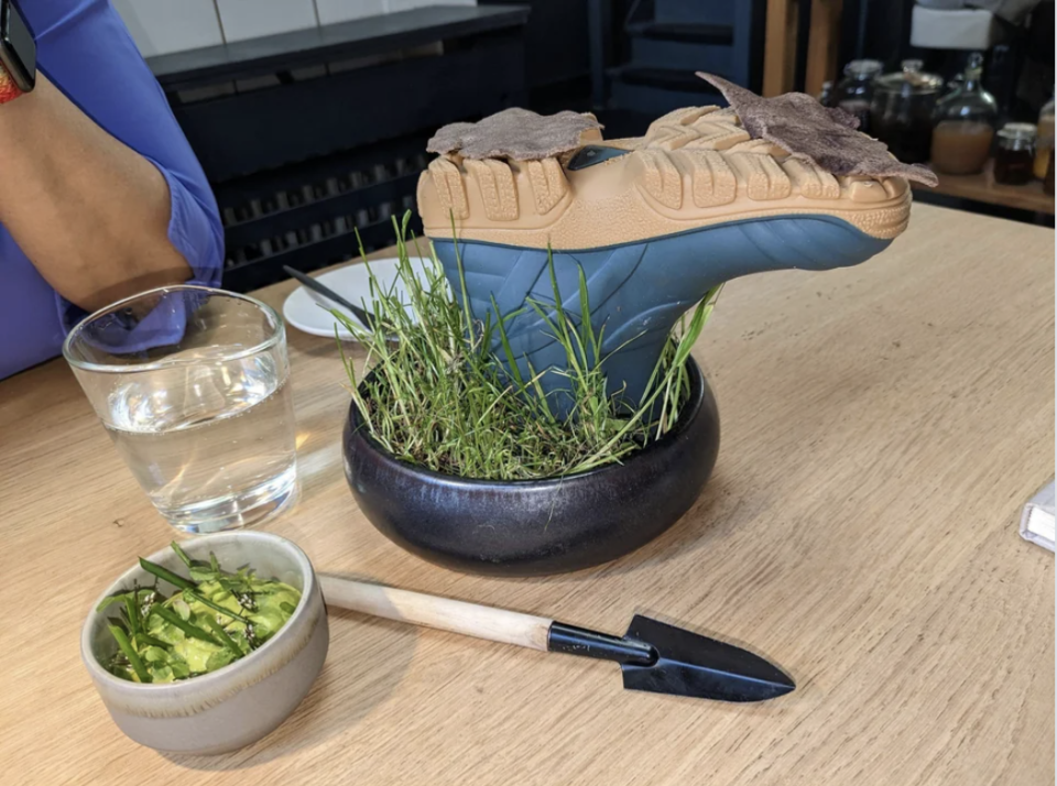 closeup of the hiking boot and mini shovel on the table