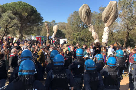 Protesters stand in front of a grove of olive trees dating back centuries in the village of Melendugno, southern Italy March 28, 2017. REUTERS/Stringer