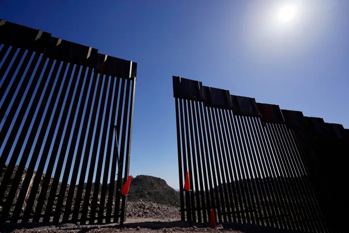 Tucson Samaritans check the border wall, including a small gap in the new construction, near Sasabe, Ariz., on Wednesday, May 19, 2021. Opponents that seek to control immigration, such as the Washington-based think tank Center for Immigration Studies, contend the border wall and other barriers are a better way to keep deaths down by keeping migrants out.