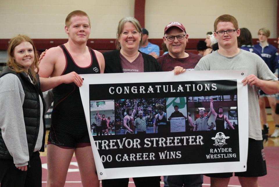 Charlevoix senior Trevor Streeter (second from left) stands with his family after earning his 100th victory of his career in late December. Streeter has only added to it since, bringing in a 7-0 record since Saturday alone.