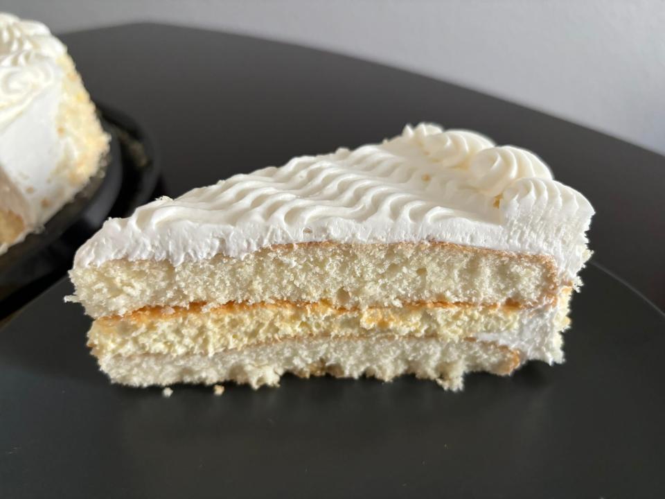 Slice of Costco vanilla cake with cheesecake layer