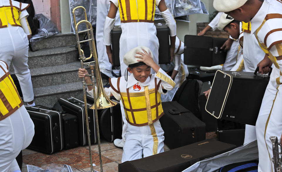Young members of a school marching band get ready for rehearsals for the Pope Francis holy mass on Thursday at the National Stadium, in Bangkok, Thailand, Wednesday, Nov. 20, 2019. Pope Francis is heading to Thailand to encourage members of a minority Catholic community in a Buddhist nation and highlight his admiration for their missionary ancestors who brought the faith centuries ago and endured persecution. (AP Photo/Manish Swarup)