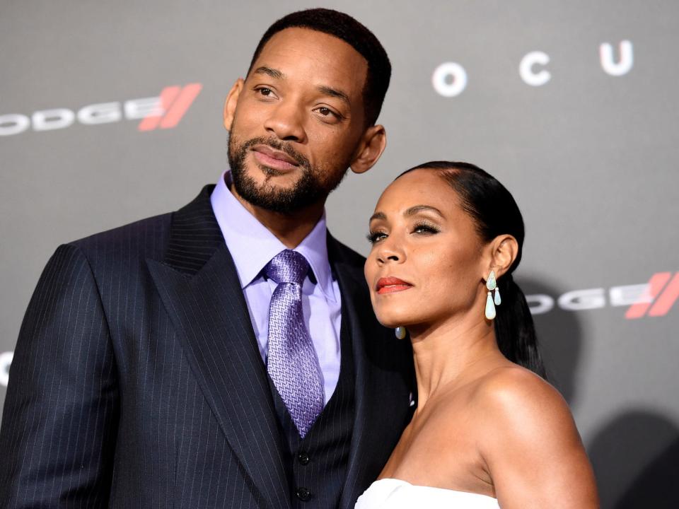 will smith jada pinkett smith pose together on the red carpet.