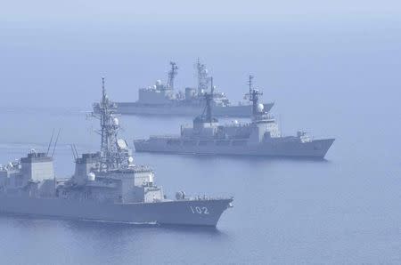 Japanese Maritime Self-Defence Force's destroyers Harusame (DD-102) and Amagiri (rear DD-154) sail side by side with Philippine warship BRP Ramon Alcaraz (PF 16) as they make a formation during their joint naval drill in the South China Sea, in this handout photo taken May 12, 2015 and released by the Maritime Staff Office of the Defense Ministry of Japan on May 13, 2015. REUTERS/Maritime Staff Office of the Defense Ministry of Japan/Handout via Reuters