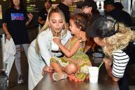 Chrissy Teigen and daughter Luna share a sweet treat during a visit to Shake Shack on Tuesday to promote NBC’s <em>Bring the Funny </em>in West Hollywood. 