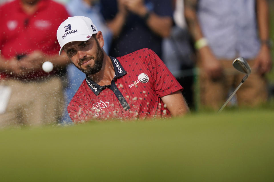 Troy Merritt hits from the sand onto the 15th green during a playoff hole in the final round of the Rocket Mortgage Classic golf tournament, Sunday, July 4, 2021, at the Detroit Golf Club in Detroit. Merritt was beaten by Cam Davis on the fifth playoff hole. (AP Photo/Carlos Osorio)