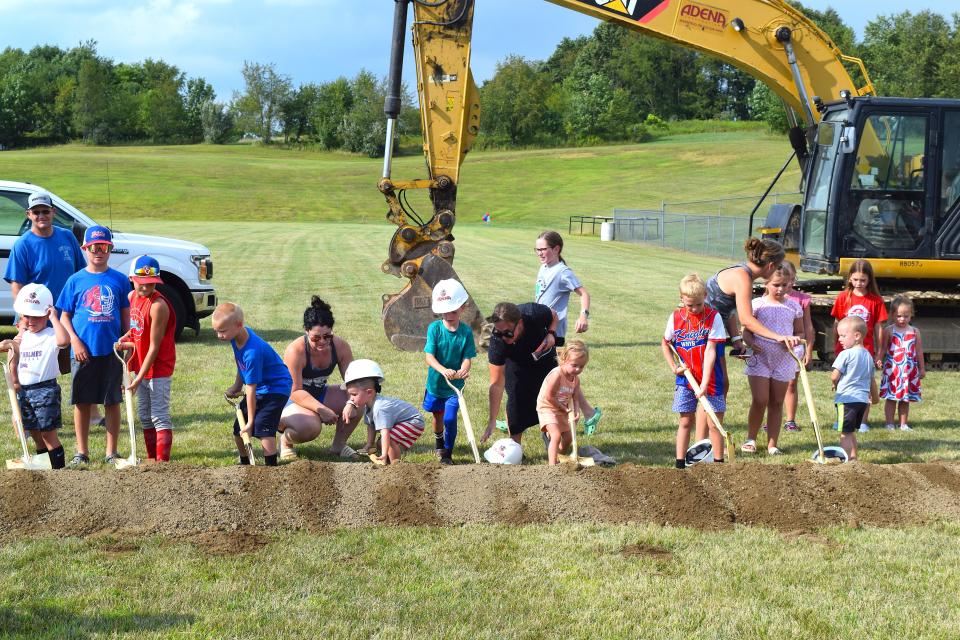 A group of West Holmes students who will someday be part of the new elementary school building get involved in digging some dirt at a ribbon-cutting ceremony Wednesday night.