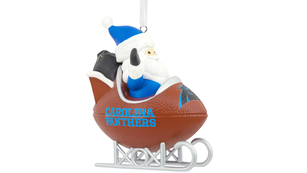 Santa in football sled with Panthers logo in front.