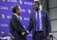 Minnesota Vikings president Mark Wilf, left, and new general manger Kwesi Adofo-Mensah shake hands after a press conference Thursday, Jan. 27, 2022 at TCO Performance Center in Eagan, Minn.(Carlos Gonzalez/Star Tribune via AP)