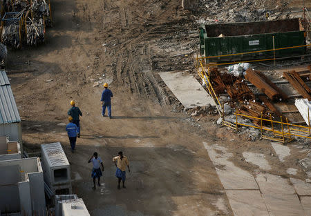 Workers walk at the construction site where locally transmitted Zika cases were first discovered in Singapore August 31, 2016. REUTERS/Edgar Su