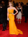 Emma Roberts looked simply chic in a tangerine-hued Escada design with a slight peplum and thin black belt.