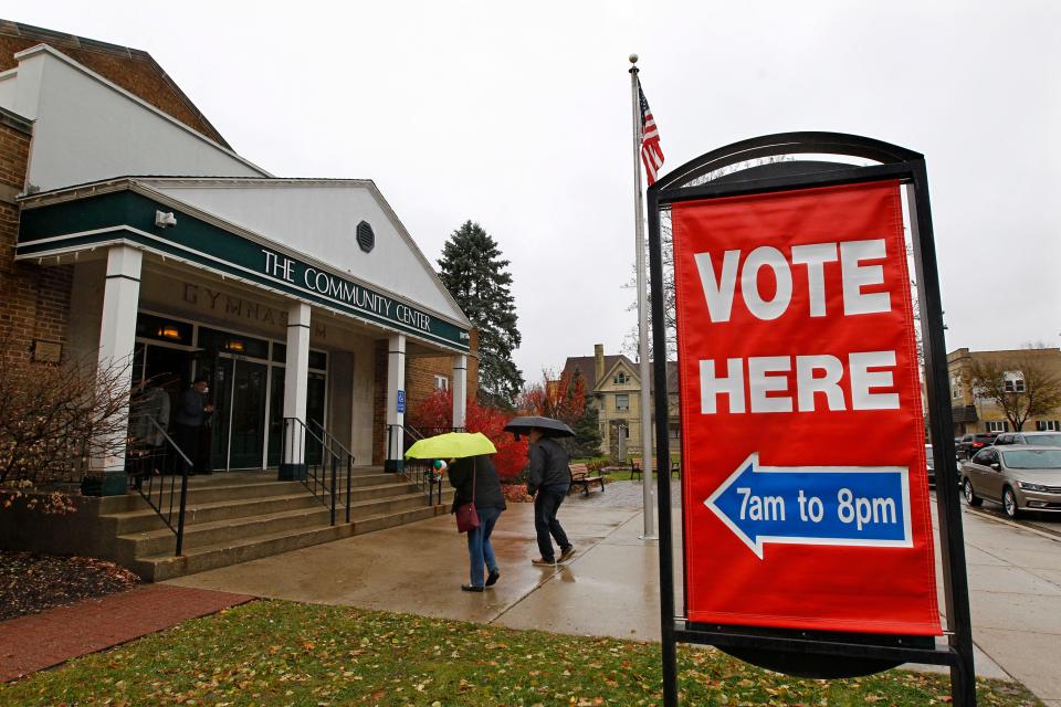 Voters brave chilly and wet weather to vote at the Community Center Gym in Cedarburg in this 2018 photo.