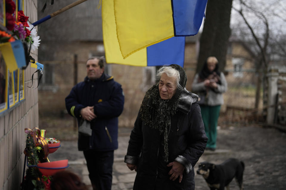 Anna Levchenko, 81, reacts during a gathering to mark the first anniversary of the death of eight men killed by Russian forces in Bucha, Ukraine, Saturday, March 4, 2023. The eight had set up a roadblock on a road in the town in an attempt to prevent Russian troops from advancing, as they swept towards the Ukrainian capital at the start of their invasion. (AP Photo/Thibault Camus)