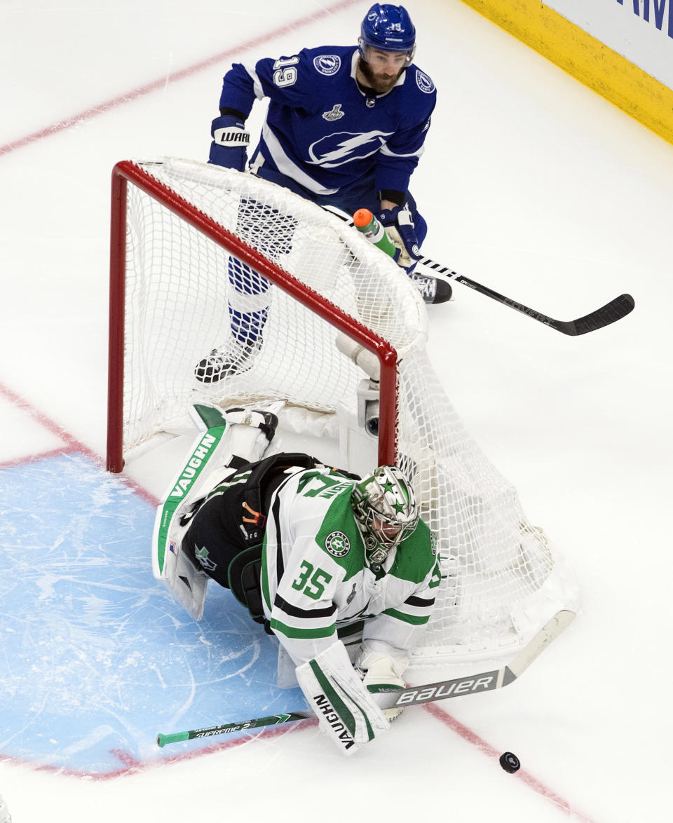 Dallas Stars goaltender Anton Khudobin (35) makes a save as Tampa Bay Lightning left wing Barclay Goodrow (19) looks for the puck during second-period NHL Stanley Cup finals hockey action in Edmonton, Alberta, Saturday, Sept. 19, 2020. (Jason Franson/The Canadian Press via AP)