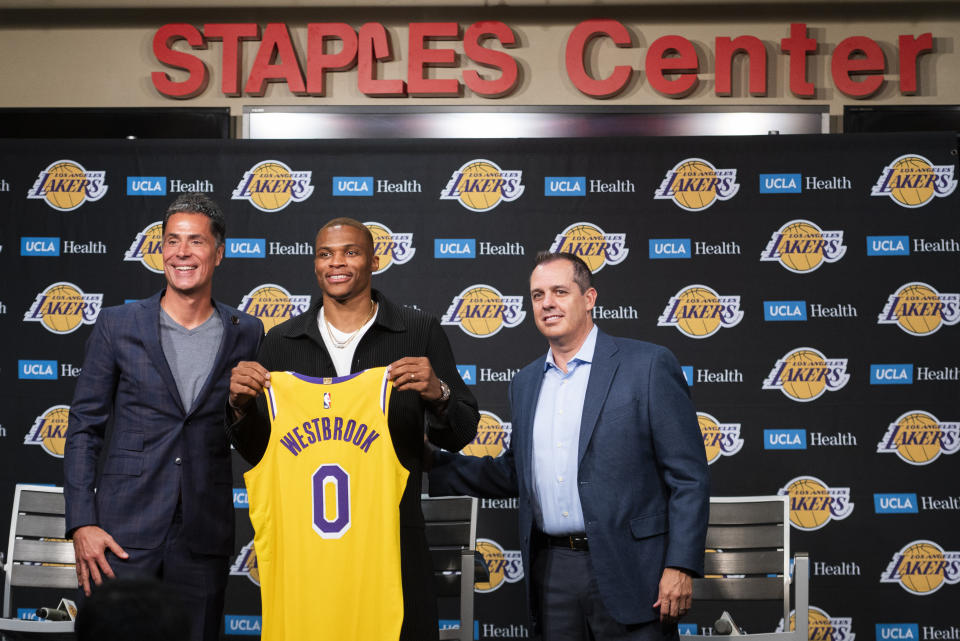 From left, Los Angeles Lakers General Manager Rob Pelinka, left, guard Russell Westbrook, and head coach Frank Vogel pose for a photo at an introductory press conference for Westbrook in Los Angeles, Tuesday, Aug. 10, 2021. (AP Photo/Kyusung Gong)