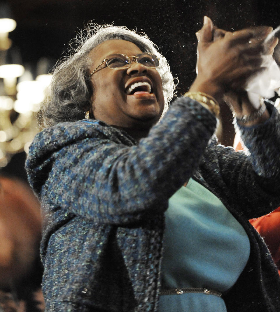 FILE - In this Monday, Jan. 21, 2013 file photo, Juanita Abernathy, widow of civil rights leader Ralph Abernathy, celebrates while watching a live video feed of President Barack Obama's inauguration after speaking at the Union League Club of Chicago in Chicago. Juanita Abernathy, who wrote the business plan for the 1955 Montgomery Bus Boycott and took other influential steps in helping to build the American civil rights movement, has died. She was 88. Family spokesman James Peterson confirmed Abernathy died Thursday, Sept. 12, 2019 at Piedmont Hospital in Atlanta following complications from a stroke. (AP Photo/Paul Beaty, File)