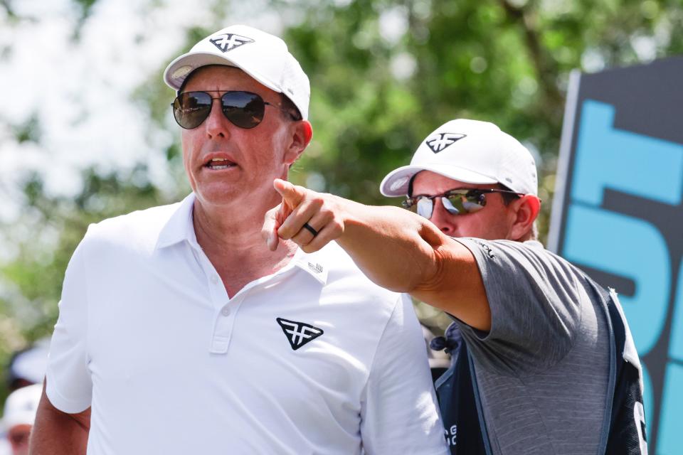 Mar 31, 2023; Orlando, Florida, USA; Phil Mickelson of the Hy Flyers (left) talks to his caddie on the second tee during the first round of a LIV Golf event at Orange County National. Mandatory Credit: Reinhold Matay-USA TODAY Sports